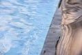 Peaceful pool reflections against black granite tiling.