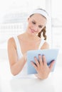 Peaceful pretty sportswoman using a tablet pc