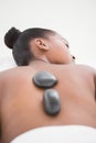 Peaceful pretty woman enjoying a hot stone massage Royalty Free Stock Photo
