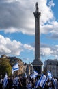 Crowds of people waving Israeli flags at pro-Israel solidarity rally at Trafalgar Square in London, UK