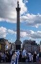 Crowds of people waving Israeli flags at pro-Israel solidarity rally at Trafalgar Square in London, UK