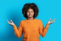 Peaceful relaxed black woman meditating on blue Royalty Free Stock Photo