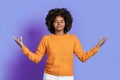 Peaceful relaxed black woman meditating on purple studio background Royalty Free Stock Photo