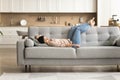 Peaceful relaxed young Indian woman resting on grey soft couch Royalty Free Stock Photo