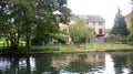 Peaceful residential area, with a paved path running alongside a tranquil canal in Apsley