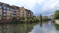 Peaceful residential area, with a paved path running alongside a tranquil canal in Apsley