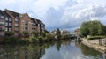 Peaceful residential area, with a paved path running alongside a tranquil canal in Apsley