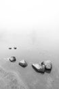 Peaceful rock,rock in the lake with fog over the lake in black and white.. Royalty Free Stock Photo