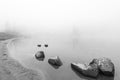 Peaceful rock,rock in the lake with fog over the lake in black and white.. Royalty Free Stock Photo
