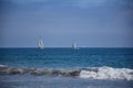 Peaceful sailing boat in open ocean at distance with blue sea Royalty Free Stock Photo