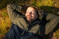 satisfied man sleeping and resting on green forest moss. nature escape and tranquility. stress relief and mental health Royalty Free Stock Photo