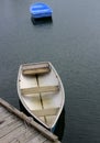 Calm waters in the harbor with row boats anchored or tied up to pier Royalty Free Stock Photo