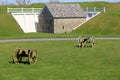 Peaceful scene of canons placed on property near old stone structure, Fort Ontario, New York, 2017