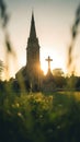 Sunset Behind Church Steeple and Cross in Quiet Village Royalty Free Stock Photo