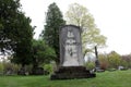 Peaceful scene of large trees surrounding old, weathered gravestone of soldier, Saratoga Monument and Victory Woods Cemetery, 2019