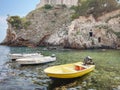 Peaceful scene of several small boats floating on a glassy body of water in Dubrovnik, Croatia