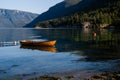 Peaceful scenery with orange wood fishing boat in the river. Norway landscape with mountains in Lustrafjord. Royalty Free Stock Photo