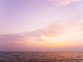 Peaceful sea scape and golden purple tone sunset or sunrise sky, tropical island ocean view at dawn or dusk Royalty Free Stock Photo
