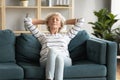 Peaceful serene mature senior lady napping alone on comfortable couch. Royalty Free Stock Photo