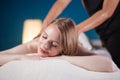 Young woman taking pleasure on massage bed, with eyes closed. Woman. Spa salon. Royalty Free Stock Photo