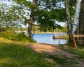 Peaceful setting of bench in park alongside Chippewa Flowage shoreline Royalty Free Stock Photo