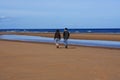 Couple Strolling On Omaha Beach, Normandy, France