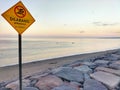 A peaceful shoreline, but with a clear warning Royalty Free Stock Photo