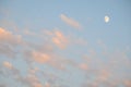 Peaceful sky at dusk, light clouds and partial moon, as a nature background