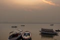 Peaceful sunrise, sunset warm landscape of river with people on the boats. Ganga river bank. Varanasi, India Royalty Free Stock Photo