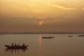 Peaceful sunrise, sunset warm landscape of river with people on the boats. Ganga river bank. Varanasi, India Royalty Free Stock Photo