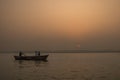 Peaceful sunrise, sunset warm landscape of river with people on the boats. Ganga river bank. Varanasi, India Royalty Free Stock Photo