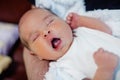 Peaceful sweet newborn infant baby lying on bed while sleeping in a bright room Royalty Free Stock Photo