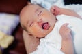 Peaceful sweet newborn infant baby lying on bed while sleeping in a bright room