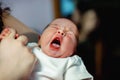 Peaceful sweet newborn infant baby lying in mother hands