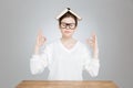 Peaceful teenage girl sitting with book on head and meditating Royalty Free Stock Photo