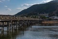 Peaceful and tranquil outdoor scene featuring the Togetsukyo Bridge in Kyoto, Japan.