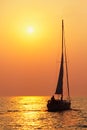 Peaceful and Tranquil sunset over the Atlantic ocean with sailboat Royalty Free Stock Photo