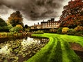 Peaceful view of lake and flowers in bloom at Biddulph Grange, Stoke-on-Trent, England