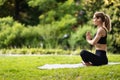 Peaceful well-fit woman meditating at public park, copy space Royalty Free Stock Photo