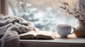 peaceful winter scene, cup on the windowsill, book and blanket Royalty Free Stock Photo
