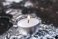 Peaceful Winter Tea Light On Cracked Ice Above A Frozen Table