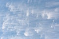 Peaceful wispy white clouds against a clean blue sky as a nature background Royalty Free Stock Photo