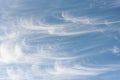 Peaceful wispy white clouds against a clean blue sky as a nature background Royalty Free Stock Photo