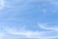 Peaceful wispy white clouds against a clean blue sky as a nature background Royalty Free Stock Photo