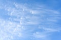 Peaceful wispy white clouds against a clean blue sky as a nature background Royalty Free Stock Photo