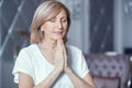 Happy woman holds hands put in prayer pose. Meditation