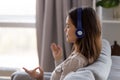 Peaceful woman in headphones listening to music and meditating