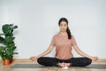 Peaceful woman practicing yoga, meditating in butterfly asana, her eyes closed Royalty Free Stock Photo