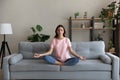 Peaceful young arab indian woman doing yoga breathing exercises.
