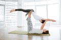 Peaceful young couple practicing acro yoga in studio Royalty Free Stock Photo